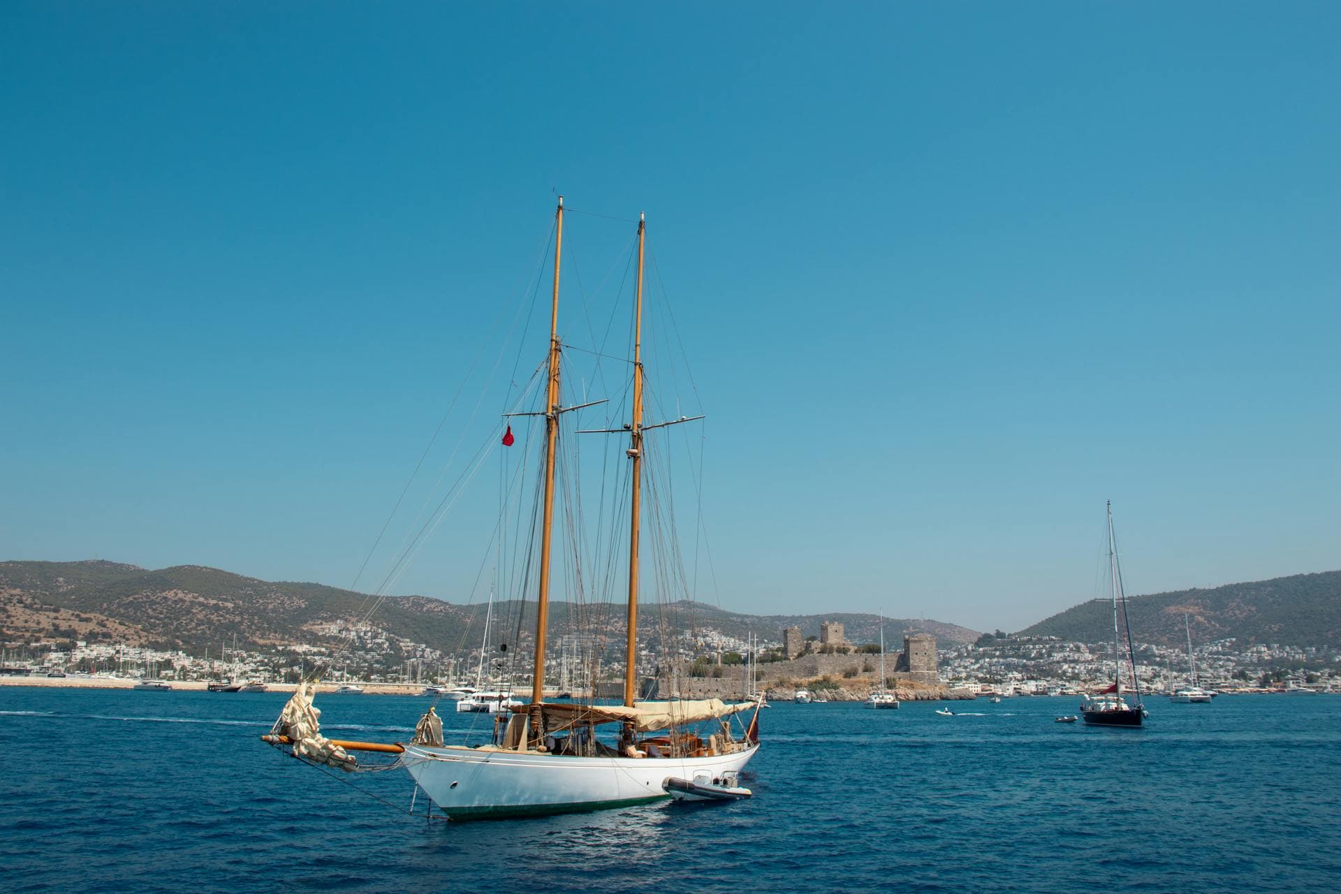hero · bodrum marina at sunset, castle behind, gulets at anchor — photo 1